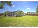 Lush backyard features a screened-in pool area, patio furniture, palm trees, and a green lawn with an open, airy feel at 2850 Babylon Ct, Oviedo, FL 32765