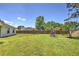 Enjoy this sprawling backyard with lush green grass, mature trees, swing set, and screened-in patio; a fantastic outdoor space at 2850 Babylon Ct, Oviedo, FL 32765