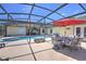 Screened-in pool area with ample seating, a dining table, and a fire pit, perfect for outdoor entertaining at 2850 Babylon Ct, Oviedo, FL 32765
