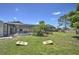Spacious backyard features a screened-in pool area, green grass, and cornhole boards for outdoor entertainment at 2850 Babylon Ct, Oviedo, FL 32765