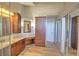 This large bathroom features a granite vanity countertop, wood cabinets, and an extra storage cabinet with drawers at 2850 Babylon Ct, Oviedo, FL 32765