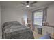 Bedroom featuring a ceiling fan, carpet flooring, large window with curtains, and a vanity makeup desk at 2850 Babylon Ct, Oviedo, FL 32765