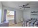 Bedroom with carpet flooring, a ceiling fan, window with blinds, closet, and shelving for storage at 2850 Babylon Ct, Oviedo, FL 32765