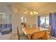 Elegant dining area with a wooden table, seating for six, and natural light, adjacent to the living room at 2850 Babylon Ct, Oviedo, FL 32765