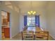 Bright dining room with wooden table, decorative chandelier, and view of the pool at 2850 Babylon Ct, Oviedo, FL 32765