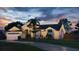 Charming single-Gathering home with a well-manicured lawn and illuminated by landscape and holiday lighting at dusk at 2850 Babylon Ct, Oviedo, FL 32765