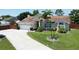 Charming single-Gathering home with a well-manicured lawn, mature palm trees, and a curved driveway at 2850 Babylon Ct, Oviedo, FL 32765