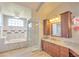 Elegant bathroom with a soaking tub, a glass-enclosed shower, and a granite-topped vanity at 2850 Babylon Ct, Oviedo, FL 32765
