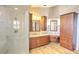 Modern bathroom featuring a walk-in shower with marble tile and custom cabinetry at 2850 Babylon Ct, Oviedo, FL 32765