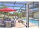 Relaxing screened-in patio with a beautiful pool, outdoor seating, and a dining area at 2850 Babylon Ct, Oviedo, FL 32765