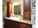 Stylish bathroom features elegant wood cabinets, granite countertops, and a bright vanity area at 2900 Cullen Lake Shore Dr, Belle Isle, FL 32812