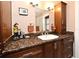 Bathroom featuring granite countertops and wood cabinets at 2900 Cullen Lake Shore Dr, Belle Isle, FL 32812