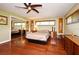 Bedroom with ceiling fan, hardwood floors, and large mirror closet at 2900 Cullen Lake Shore Dr, Belle Isle, FL 32812