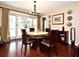 Bright dining room with wood floors, chandelier, decorative plates, and access to the outdoor pool at 2900 Cullen Lake Shore Dr, Belle Isle, FL 32812