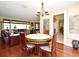 Inviting dining room with hardwood floors, charming chandelier, and views into the living spaces at 2900 Cullen Lake Shore Dr, Belle Isle, FL 32812