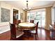 Dining room with a round table and chairs, hardwood floors, and sliding doors to the outdoor space at 2900 Cullen Lake Shore Dr, Belle Isle, FL 32812