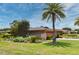 Lovely single-story home featuring a palm tree, lush landscaping, and a driveway at 2900 Cullen Lake Shore Dr, Belle Isle, FL 32812