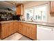 Bright kitchen featuring light wood cabinetry, neutral countertops, and stainless steel appliances at 2900 Cullen Lake Shore Dr, Belle Isle, FL 32812