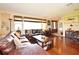 Spacious living room featuring hardwood floors, comfortable seating, and ample natural light, perfect for relaxation at 2900 Cullen Lake Shore Dr, Belle Isle, FL 32812