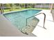 Inviting in-ground pool with clear, refreshing water and convenient steps for easy access and enjoyment at 2900 Cullen Lake Shore Dr, Belle Isle, FL 32812