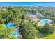 Aerial view of community amenities including a pool, splash pad, and clubhouse with lush landscaping at 304 Rum Run # 304, Davenport, FL 33897