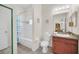 Bathroom featuring a shower-tub combo with flamingo curtain, vanity, and toilet at 304 Rum Run # 304, Davenport, FL 33897