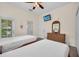 Bedroom featuring two twin beds, TV, dresser, and access to the bathroom and patio at 304 Rum Run # 304, Davenport, FL 33897