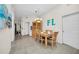 Cozy dining area with modern light fixture, wooden table set for six, and views into the living area at 304 Rum Run # 304, Davenport, FL 33897