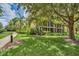 Condominium exterior surrounded by lush greenery and landscaping, showcasing a peaceful environment at 304 Rum Run # 304, Davenport, FL 33897