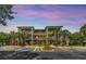 Attractive condominium building with tropical landscaping, ample parking, and private balconies for each unit at 304 Rum Run # 304, Davenport, FL 33897