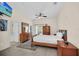 Relaxing main bedroom with tile floor, ceiling fan, and dresser at 304 Rum Run # 304, Davenport, FL 33897