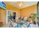 Screened-in patio with a table and chairs, offering a relaxing outdoor space at 304 Rum Run # 304, Davenport, FL 33897