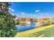 Scenic pond with a fountain surrounded by well-manicured lawns and lush landscaping at 304 Rum Run # 304, Davenport, FL 33897