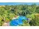 Aerial view of community splash pad with play structures and colorful seating areas surrounded by lush landscaping at 304 Rum Run # 304, Davenport, FL 33897