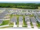 View of several homes in a residential neighborhood surrounded by lush greenery at 30498 Pintail Dr, Leesburg, FL 34748