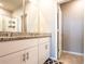 Bathroom features a vanity with granite countertop and dual sinks at 30498 Pintail Dr, Leesburg, FL 34748