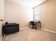 Neutral bedroom featuring a small desk and chair along with a sofa at 30498 Pintail Dr, Leesburg, FL 34748