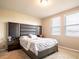 Sunlit bedroom with a statement upholstered headboard and bright, natural light at 30498 Pintail Dr, Leesburg, FL 34748