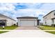 Single-Gathering home with a brick-paved driveway, two-car garage, and well-maintained landscaping at 30498 Pintail Dr, Leesburg, FL 34748