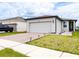 Charming single-Gathering home with a two-car garage, brick paved driveway, and manicured landscaping at 30498 Pintail Dr, Leesburg, FL 34748