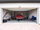 View of an open garage with a disassembled vehicle and various tools at 30498 Pintail Dr, Leesburg, FL 34748