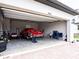 View of an open garage with a disassembled vehicle and various tools at 30498 Pintail Dr, Leesburg, FL 34748