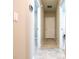 Hallway showcasing tile floors, neutral paint, and doorways to rooms at 30498 Pintail Dr, Leesburg, FL 34748