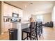 Bright kitchen features an island with granite countertops, stainless steel appliances, and tile backsplash at 30498 Pintail Dr, Leesburg, FL 34748