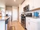 Inviting kitchen with stainless steel appliances, granite countertops, and white subway tile backsplash at 30498 Pintail Dr, Leesburg, FL 34748