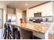 Spacious kitchen featuring granite island with seating, stainless appliances, and plenty of counter space at 30498 Pintail Dr, Leesburg, FL 34748