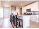 Bright kitchen with white cabinets, granite countertops, stainless steel appliances, and a breakfast bar at 30498 Pintail Dr, Leesburg, FL 34748