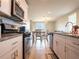 Modern kitchen with stainless steel appliances, white cabinetry, granite countertops, and an open design at 30498 Pintail Dr, Leesburg, FL 34748