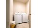 Laundry room with a washer and dryer, neutral walls, and tile flooring at 30498 Pintail Dr, Leesburg, FL 34748