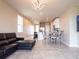 Open-concept living room with tile flooring, kitchen island, and dining area providing an inviting space at 30498 Pintail Dr, Leesburg, FL 34748